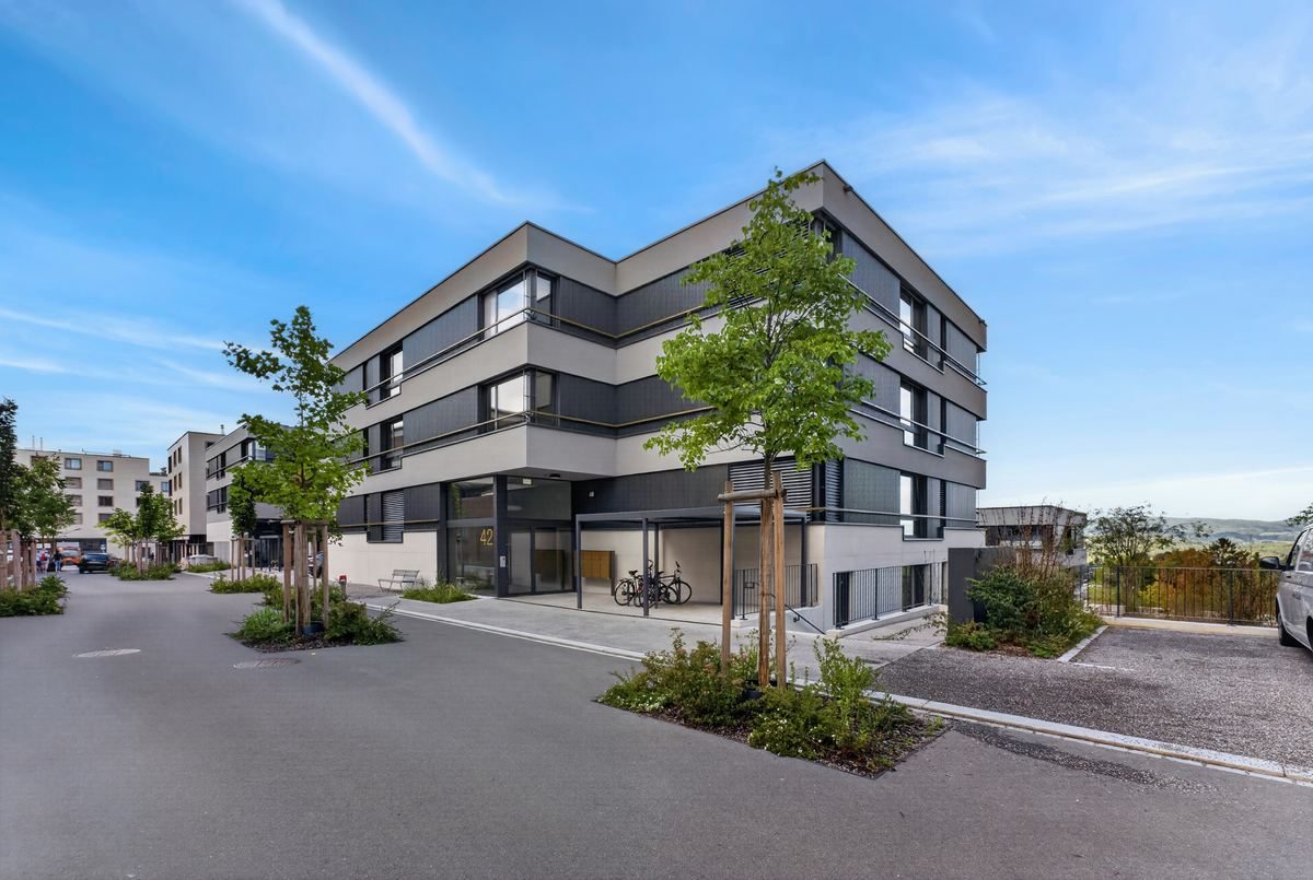 Apartment building after sky replacement, clean blue sky